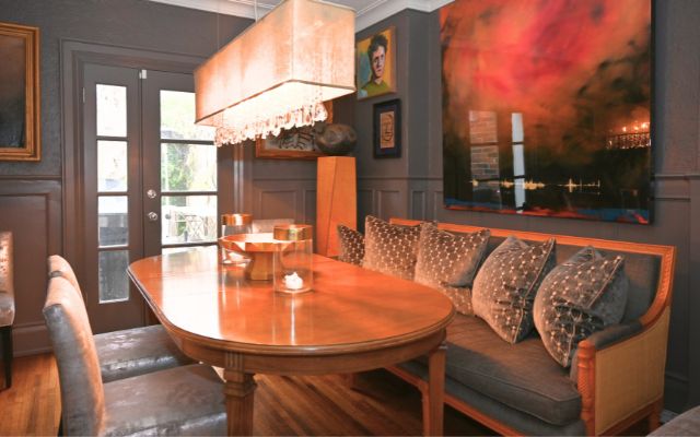 A dramatic dining space layered with art, texture, and atmosphere.