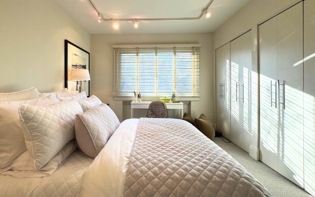 Layered textiles and warm light in the primary suite.